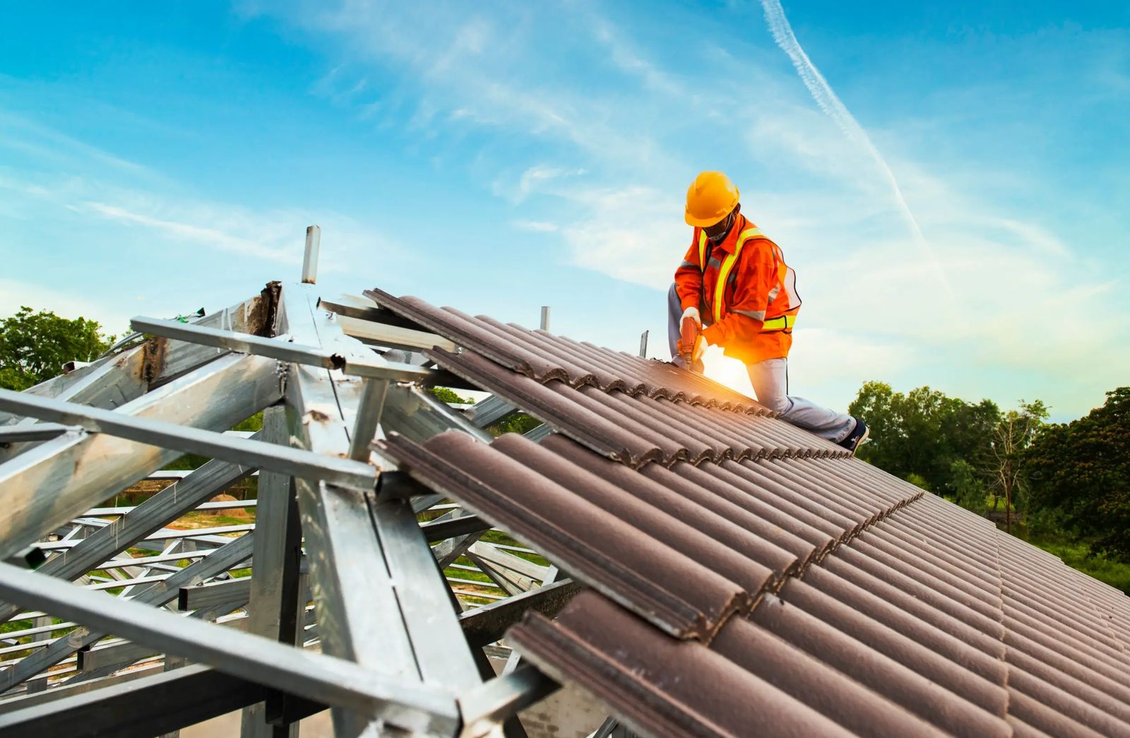 Roofing contractor laying new roof sheets on a timber roof structure